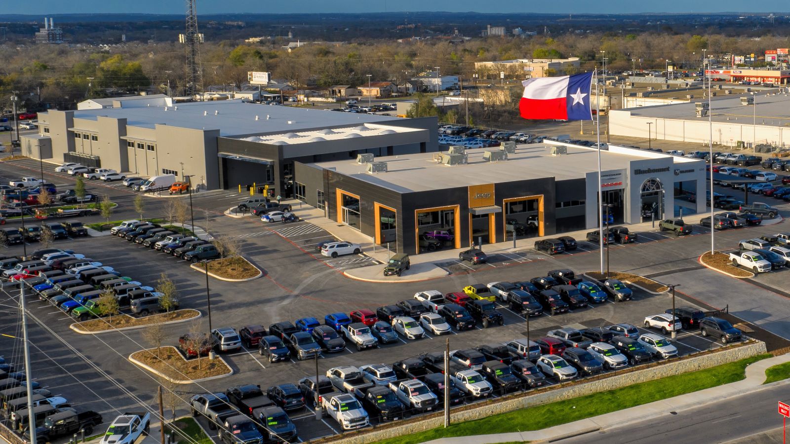 Aerial view of automotive dealership with parking and service buildings in New Braunfels, Texas commercial architecture